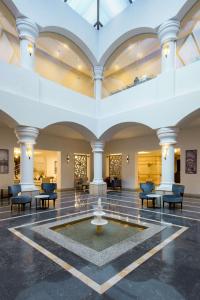 a lobby with a fountain in the middle of a room at Marina Resort Port Ghalib, a member of Radisson Individuals in Port Ghalib +37 photos
