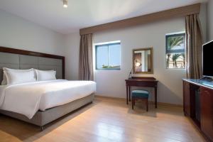 A bed or beds in a room at Marina Resort Port Ghalib, a member of Radisson Individuals