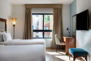 A bed or beds in a room at Marina Resort Port Ghalib, a member of Radisson Individuals
