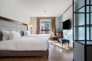 A bed or beds in a room at Marina Resort Port Ghalib, a member of Radisson Individuals
