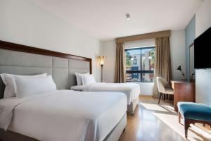 A bed or beds in a room at Marina Resort Port Ghalib, a member of Radisson Individuals