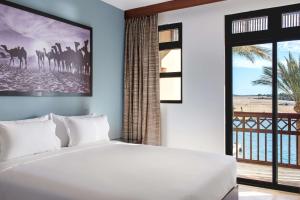 A bed or beds in a room at Marina Resort Port Ghalib, a member of Radisson Individuals