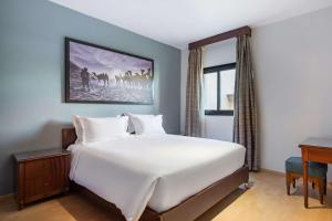 A bed or beds in a room at Marina Resort Port Ghalib, a member of Radisson Individuals
