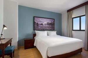 A bed or beds in a room at Marina Resort Port Ghalib, a member of Radisson Individuals