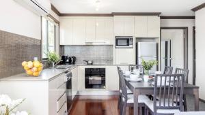 a kitchen with a table and a dining room at Lionel Gem in Shoal Bay