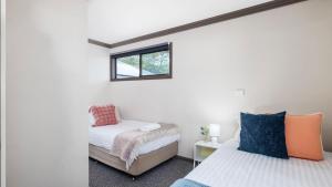 a bedroom with two beds and a window at Lionel Gem in Shoal Bay +23 photos