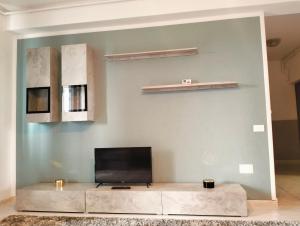 a living room with a flat screen tv on a wall at GOLDEN APARTMENT- Militari Residence Bucharest in Dudu