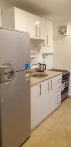 eine Küche mit Kühlschrank und Spüle in der Unterkunft El Kheima Beach Resort in Sharm El Sheikh