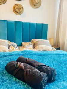 a person laying on a blue blanket on a bed at MoryńApartments R20 in Moryń