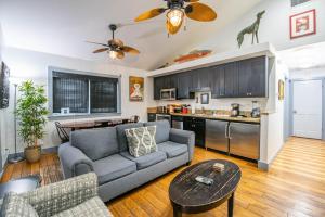 a living room with a couch and a kitchen at Pescado Penthouse in Key West