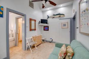 a living room with a blue couch and a bedroom at Yellowfin Ledge in Key West
