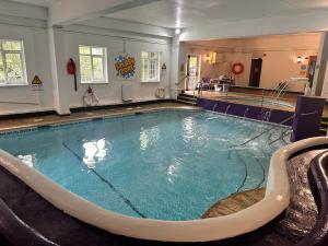 a large swimming pool in a hotel room at SeaBreeze Lodge, located between Penzance & St Ives - A sanctuary to relax & unwind with activities on the doorstep for all the family in Penzance