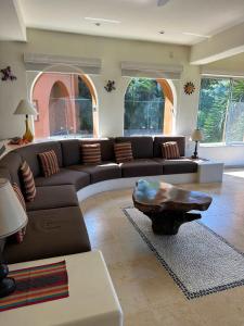 a living room with a couch and a coffee table at Luxury Residence at Vista Bay 103 in Zihuatanejo