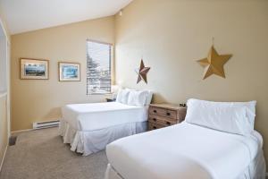 two beds in a room with stars on the wall at Walk to Lift, Sleeps 6, Shared Hot Tub, Cozy Interiors, Gourmet Dining, Fireplace and Patio in Park City +36 photos