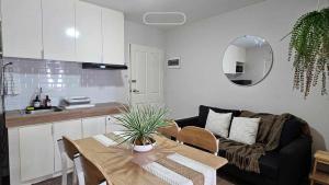 a kitchen and a living room with a table and a couch at Marina Oasis Two Bed Room Condo Unit in Dumaguete