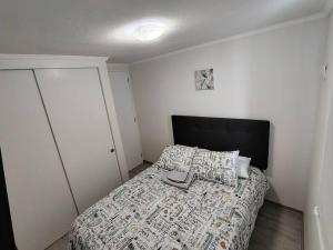 a bedroom with a bed with a book on it at Exclusivo Departamento con Vista Panorámica al Mar a Solo 50 Metros de la Playa in La Serena +28 photos