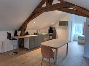 a kitchen and dining room with a table in a room at Loire and Baluchon in Ancenis +5 photos