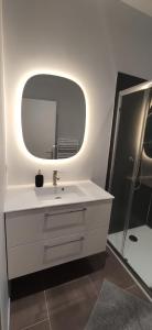 a bathroom with a white sink and a mirror at Loire and Baluchon in Ancenis