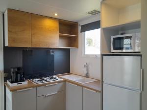 a kitchen with a white refrigerator and a microwave at Charming Breebos Getaway in Rijkevorsel