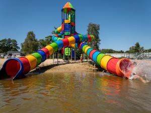 a water slide in the water at a playground at Charming Breebos Getaway in Rijkevorsel