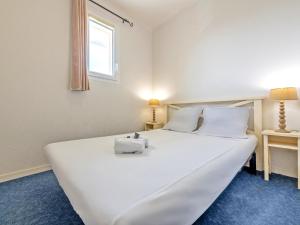 a large white bed in a room with a window at Flat by Pointe St-Mathieu in Plougonvelin +14 photos