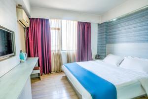 A bed or beds in a room at Juli Boutique Hotel