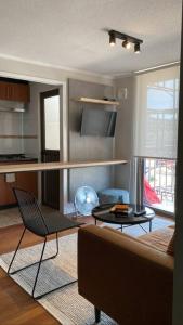 a living room with a couch and a table at Apartamento amoblado in Talca