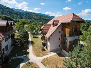 an overhead view of a building with a mountain in the background at Alpine Getaway with Pool in Giez