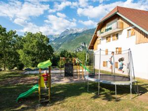 a playground in a yard next to a house at Retreat Near Lake Annecy in Giez +32 photos