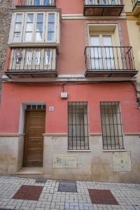 a red building with windows and a door at Letmalaga Lenid in Málaga