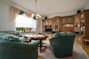 a living room with two chairs and a table at Ferienhaus-Kirschbluete in Rechlin