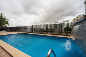 a swimming pool with a water fountain in front of a building at George Residence Banana Island Road, Ikoyi in Lagos