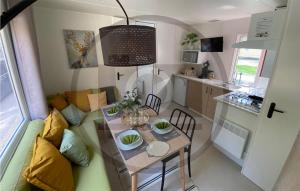 a small living room with a table and a kitchen at Waldcamping Am Brombachsee in Pleinfeld