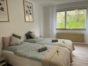 a bedroom with a bed with two towels on it at Apartment AlbGlück 2 Hechingen, 3 Schlafzimmer, 1-7 Personen, Burg 5 km in Hechingen +20 photos