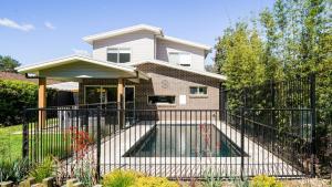a black fence in front of a house at Blissful Bungalow in Culburra Beach +18 photos