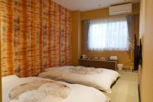 Postel nebo postele na pokoji v ubytování KIMIEN Hotel