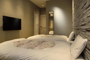 Postel nebo postele na pokoji v ubytování KIMIEN Hotel