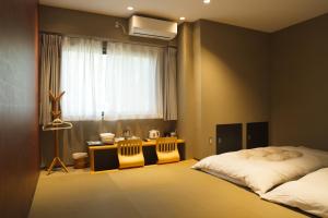 Postel nebo postele na pokoji v ubytování KIMIEN Hotel