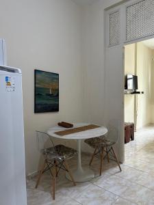 a white table and two chairs in a room at Copacabana POSTO 4 Temporada in Copacabana