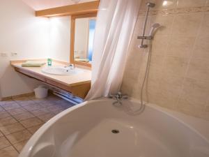 a bathroom with a tub and a sink at Savoy Style Mountain Stay in Giez +31 photos