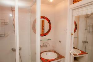 a bathroom with a shower and a sink at Arzipreste IV La Casita del Jardín in León +16 photos