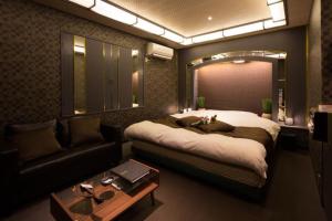 a bedroom with a large bed and a couch at プリンセスプリンセス秋田大町 in Akita +14 photos