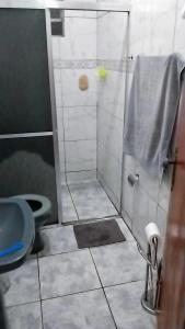 a bathroom with a shower with a toilet and a sink at Casa aconchegante in Mendanha
