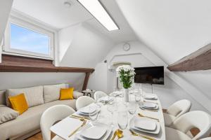 a dining room with a white table and chairs at STARLIVING Premium Home in Osthofen