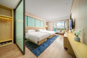 Krevet ili kreveti u jedinici u okviru objekta Echarm Hotel Kunming Changshui International Airport