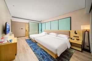 Krevet ili kreveti u jedinici u okviru objekta Echarm Hotel Kunming Changshui International Airport