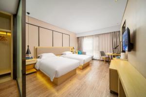 TV i/ili multimedijalni sistem u objektu Echarm Hotel Kunming Changshui International Airport