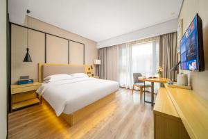 Krevet ili kreveti u jedinici u okviru objekta Echarm Hotel Kunming Changshui International Airport