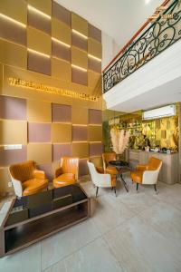 a lobby of a hotel with orange and white chairs at Simmi 6 Hotel & Apartment in Ho Chi Minh City