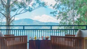 a table with drinks on top of a balcony at The Farm Resorts in Hatton